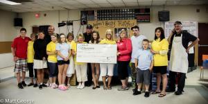 Andrea and Becky's Family Members hold a cheque for nearly $67 000 at then end of last year's Funfest